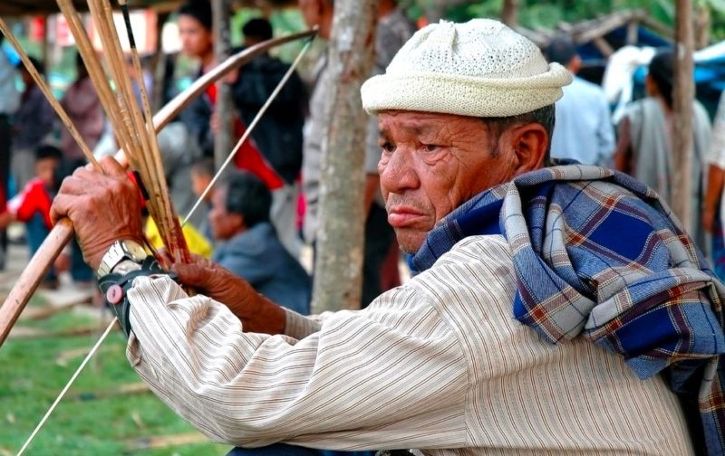 An old Khasi archer waits for the teer to start
