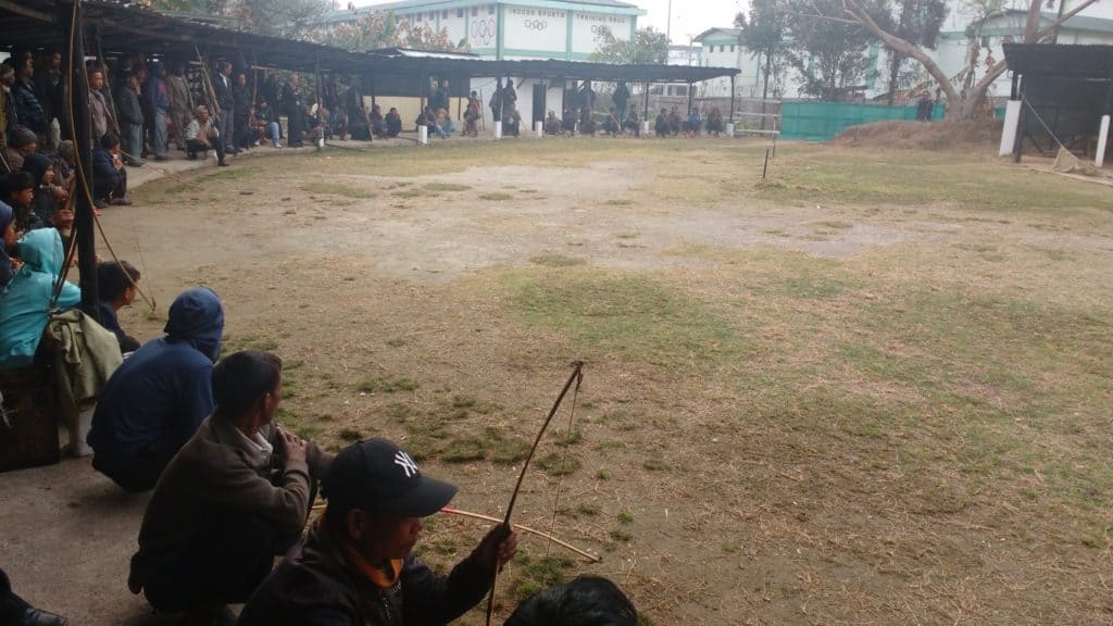 Khasi archers gather around the target, preparing to take their aim