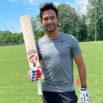 Unmukt Chand holding a cricket bat